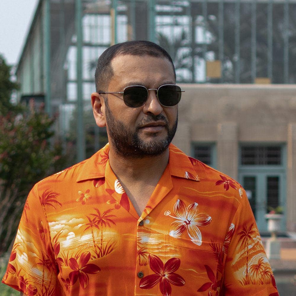 Glascoe Sunglasses by Carsten Boyd. Silver wirh black polarized lenses. Worn view.