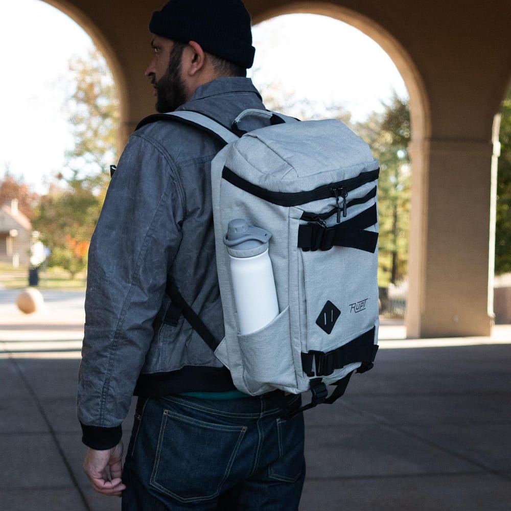 Paso 20L Backpack by Rupt in gray. Left-side worn view.